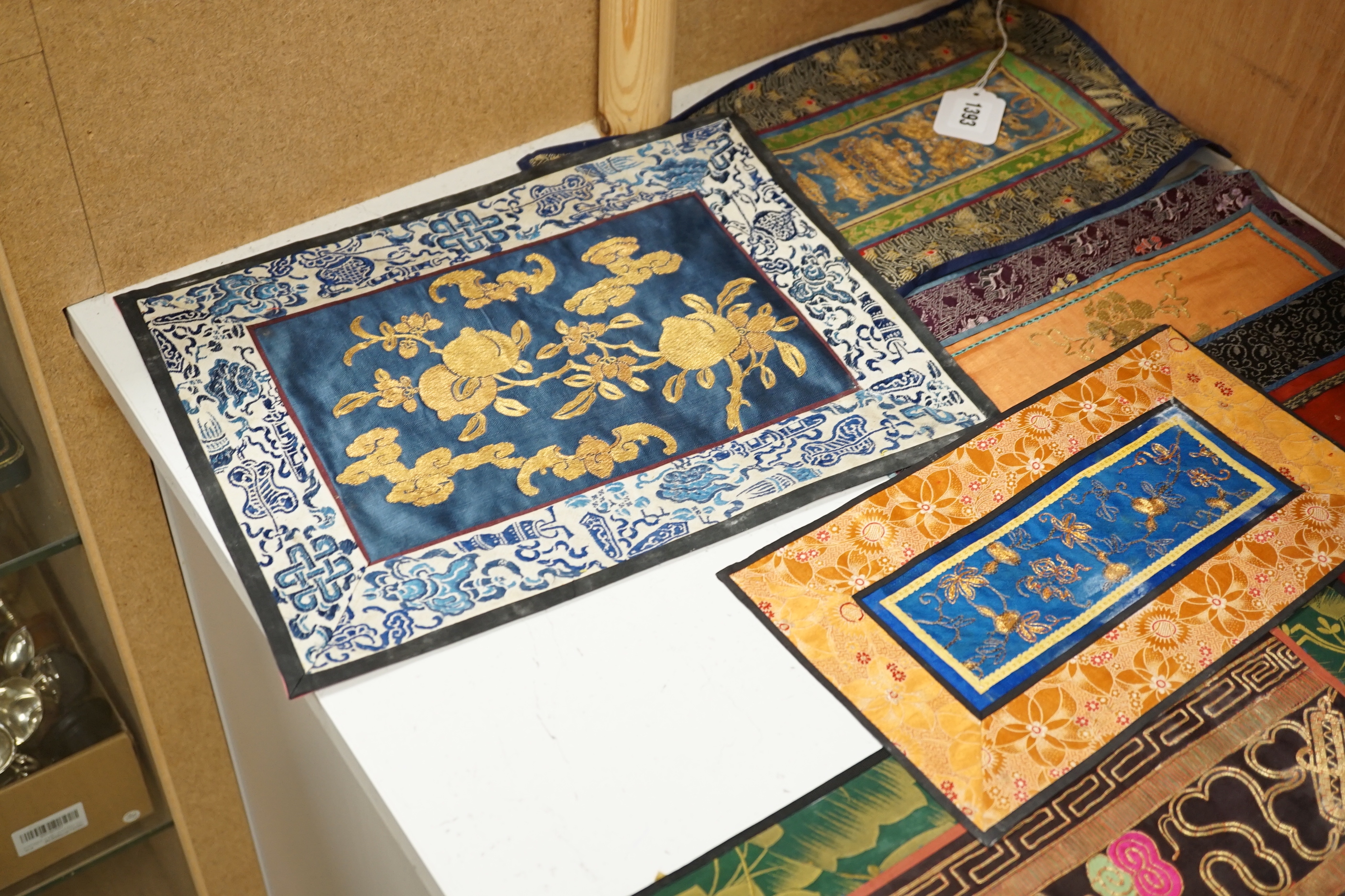 Nine Chinese silk embroidered panels, embroidered with gold thread and bordered with silk damask and brocade